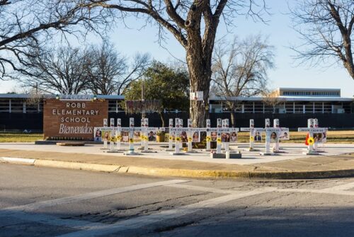 Memorial crosses outside Robb Elementary School in Uvalde on Jan. 18, 2024. The now-closed school was the site of the May 2022 mass shooting that left 19 children and two teachers dead. 
